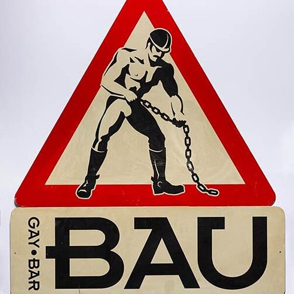 Verkehrszeichen, mit einem stilisierten muskulösen Bauarbeiter in der Mitte und dem Hinweiß “GAY, BAR, BAU“