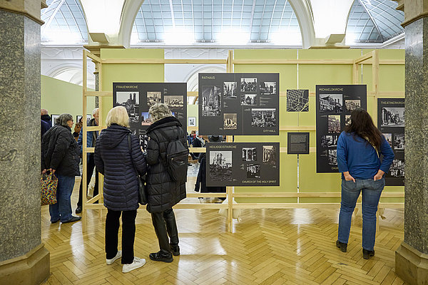 Ausstellungsbesucher vor der Lattenkonstruktion von hinten aufgenommen